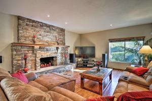 a living room with a couch and a fireplace at Red Mountain Mesa Oasis Pool, Bar and Game Room! in Mesa