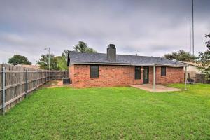a brick house with a fence in a yard at Lubbock Home with Backyard - 6 Mi to Texas Tech in Lubbock