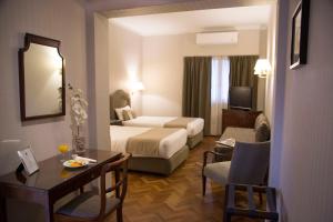a hotel room with a bedroom with a bed and a desk at Lafayette Hotel in Buenos Aires +75 photos