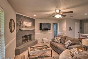 a living room with a couch and a fireplace at Lubbock Home with Backyard - 6 Mi to Texas Tech in Lubbock