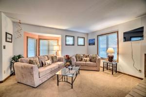 a living room with two couches and a table at Pagosa Springs Condo, 4 Miles to Hot Springs! in Pagosa Springs