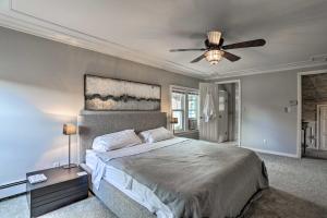 a bedroom with a bed and a ceiling fan at Lake Hopatcong Family Home with Boat Slip and Dock in Hopatcong
