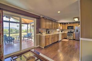 a kitchen with wooden cabinets and a sliding glass door at JuJus House with Mtn View, 16 Mi to Pigeon Forge! in Seymour