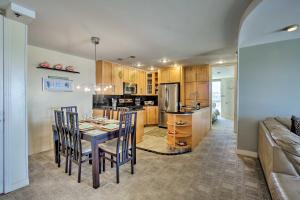 a kitchen and dining room with a table and chairs at Beachfront Oceanside Condo with Pool and Hot Tub! in Oceanside