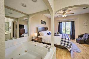 a bathroom with a bed and a tub in a room at The Ridge Branson Condo with Pools and Golf Course! in Branson +17 photos