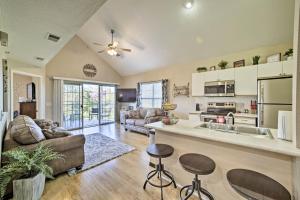 a large living room with a couch and a kitchen at The Ridge Branson Condo with Pools and Golf Course! in Branson