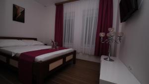 a bedroom with a bed and a window at Hotel Rafaelo -Kozarska Dubica- BiH in Bosanska Dubica