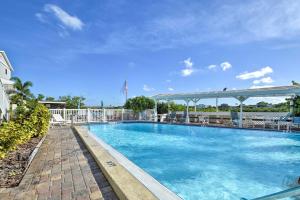 a swimming pool at a resort with at Indian Shores Townhome with Pool Access and Kayaks! in Clearwater Beach