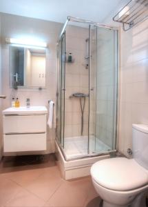 a bathroom with a shower and a toilet and a sink at Belville Luxury Apartment in Belgrade +16 photos