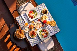 a table topped with plates of food and drinks at Alp Pasa Hotel - Special Class in Antalya