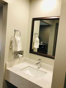 a bathroom with a sink and a mirror at BEL AIR MOTEL in Wood River +31 photos