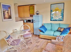 a living room with a couch and a table at Sea Moss Cabin in Tywyn