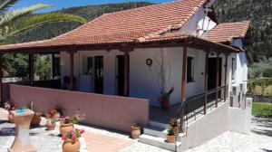 a house with a terrace with potted plants at House of Garden in Dhráganon