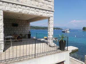 a house with a view of the water and a boat at Apartment Marne in Lumbarda