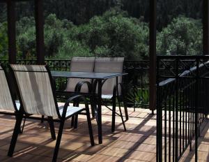 two chairs and a table on a deck at House of Garden in Dhráganon