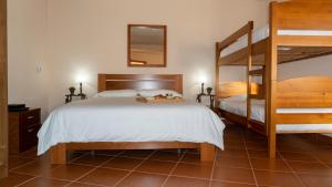 a bedroom with two beds and a bunk bed at OceanFront Studio - Casa Santo Antonio in São Mateus