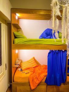 a bedroom with two bunk beds in a room at Charruas hostel in Montevideo