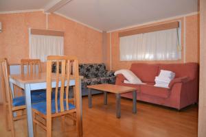 a living room with a couch and a table at Camping Fuentes Blancas in Burgos