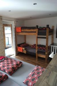 a room with two bunk beds and a table at Ferienhaus Skiblume in Oetz