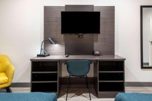 a desk with a monitor and a blue chair at Studio 6-Mesquite, TX - Dallas in Mesquite