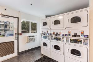 a laundry room with four washer and dryer machines at Motel 6-Jacksonville, FL - South in Sunbeam