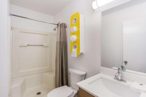 a white bathroom with a toilet and a sink at Studio 6 Extended Stay - Jacksonville, FL - South in Sunbeam