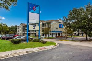 a gas station sign in front of a parking lot at Motel 6-Jacksonville, FL - South in Sunbeam