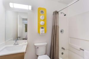 a bathroom with a toilet and a sink and a tub at Motel 6-Jacksonville, FL - South in Sunbeam