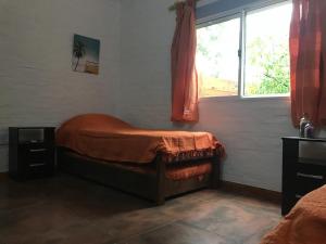 a small bedroom with a bed and a window at la vidurria -rre in Piriápolis