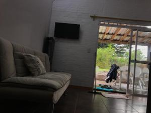 a living room with a couch and a sliding glass door at la vidurria -rre in Piriápolis