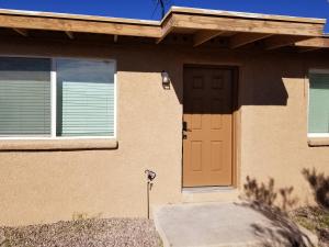 a house with a orange door and windows at Southwest Tucson Gateway in Tucson