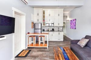 a living room with a couch and a kitchen at Mangata Villas Adults Only in San Pedro