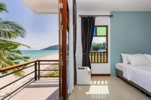 a bedroom with a bed and a view of the beach at The Boutique Khanom in Khanom
