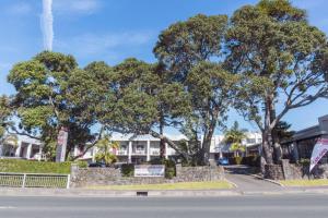 uma rua com árvores em frente a um edifício em Mt Albert Motor Lodge em Auckland