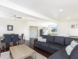 a living room with a couch and a table at Driftwood House in Port Fairy
