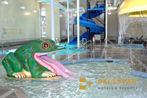 a statue of a frog in a pool of water at Grande Rockies Resort-Bellstar Hotels & Resorts in Canmore