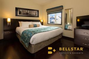 a hotel room with a bed and a television at Grande Rockies Resort-Bellstar Hotels & Resorts in Canmore