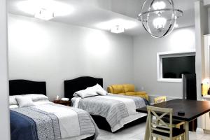 1 Schlafzimmer mit 2 Betten, einem Tisch und einem Esszimmer in der Unterkunft Aurora Guest house in Yellowknife