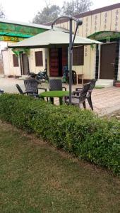 a group of chairs and a table in front of a building at Radha Krishna Dham in Vrindāvan +16 photos