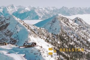 a snow covered mountain with a lodge on top of it at Glacier & Mountaineer Lodge in Golden