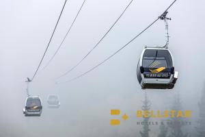 two lifts in the sky in the fog at Glacier & Mountaineer Lodge in Golden
