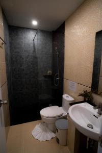 a bathroom with a shower and a toilet and a sink at Ban's Avenue Guesthouse in Koh Tao +18 photos