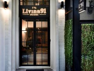a door to a store with a sign on it at Livinn91 Hotel in Bangkok