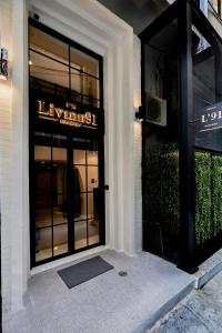 a entrance to a luxury store with a sign on the door at Livinn91 Hotel in Bangkok
