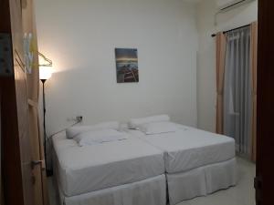 Postel nebo postele na pokoji v ubytování Villa Taribandung