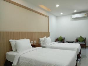A bed or beds in a room at Nine Smiths Hotel Chiangmai