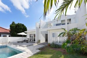 a villa with a swimming pool and a house at Route 6 Inn in Yomitan