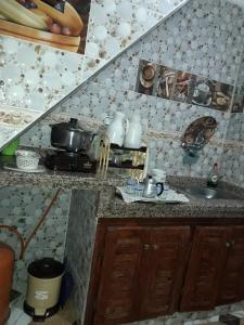 a kitchen with a sink and a counter top at Maison Bahija in Chefchaouen