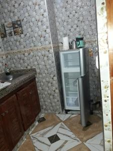 a small kitchen with an open refrigerator in the corner at Maison Bahija in Chefchaouen