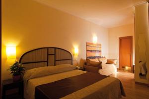 Postel nebo postele na pokoji v ubytování Hotel Novecento